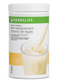 Herbalife meal replacement powder container with a glass of milk on a white background
